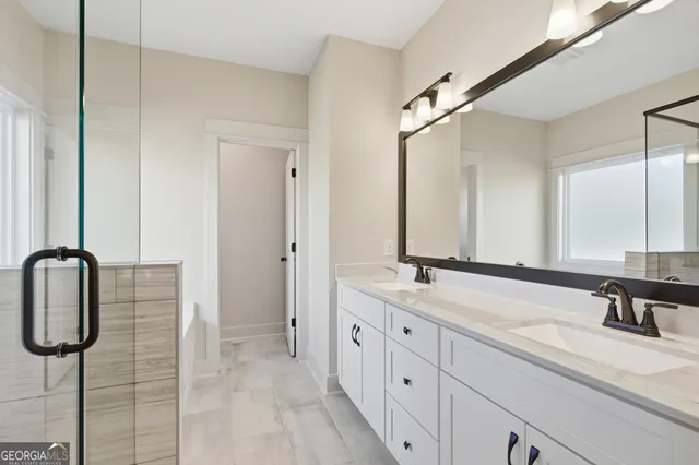 a bathroom with a double vanity sink and mirror