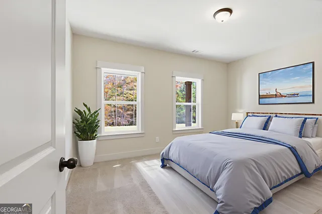 a bedroom with a bed potted plant with the window
