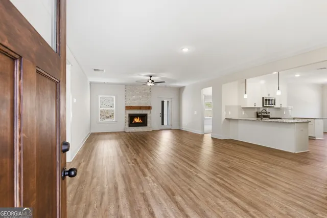 a view of kitchen and hall with wooden floor
