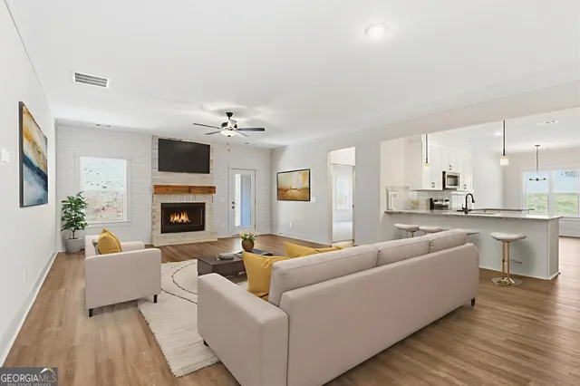 a living room with furniture and a fireplace