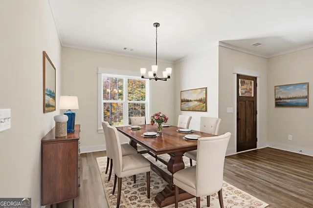 a view of a dining room with furniture window and wooden floor