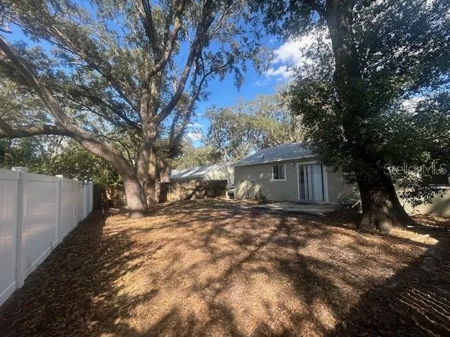 a view of a yard with large trees