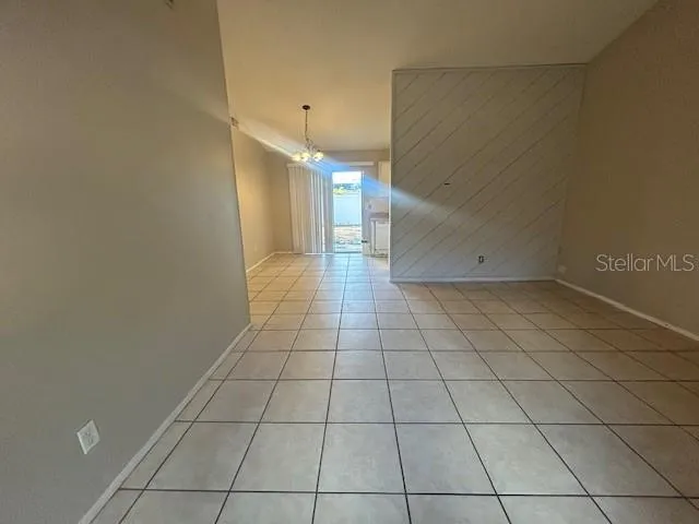 a view of a livingroom with an empty space and a window