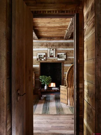 a living room with couches a rug and a table with wooden floor