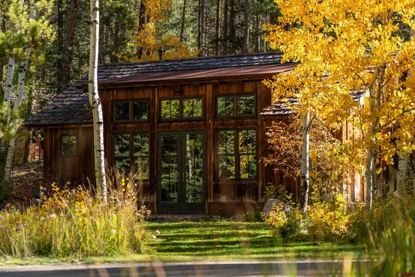 a living room with furniture a rug and a floor to ceiling window