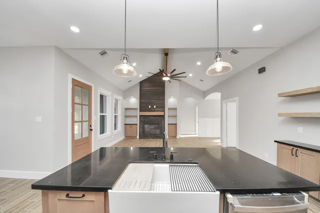 a kitchen with stainless steel appliances granite countertop a sink a oven and a refrigerator