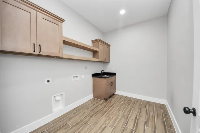 a kitchen with cabinets and wooden floor