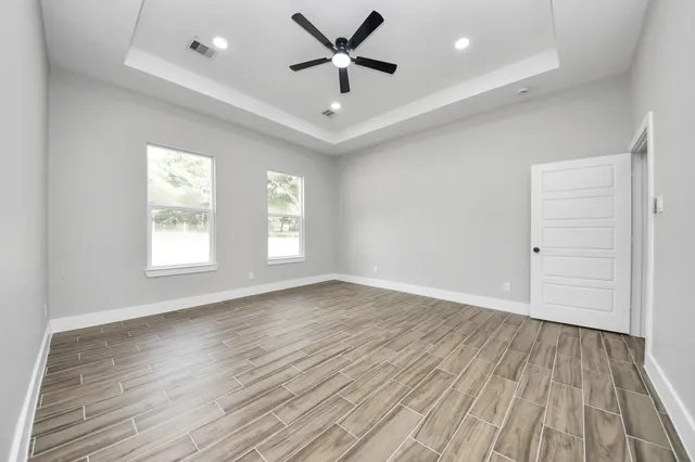 wooden floor in an empty room with a window