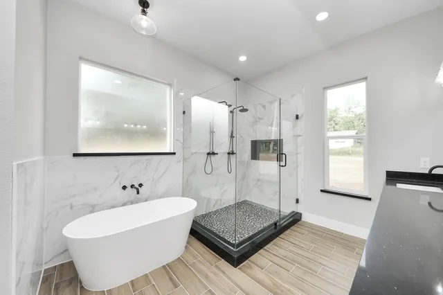 a bathroom with a bathtub and shower