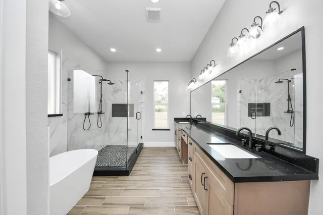 a large bathroom with a large tub and sink