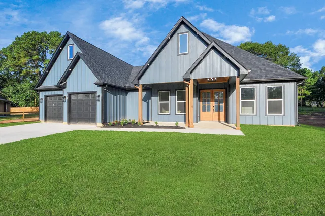 a front view of a house with a yard and porch