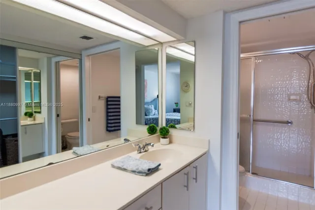 a bathroom with a glass shower door