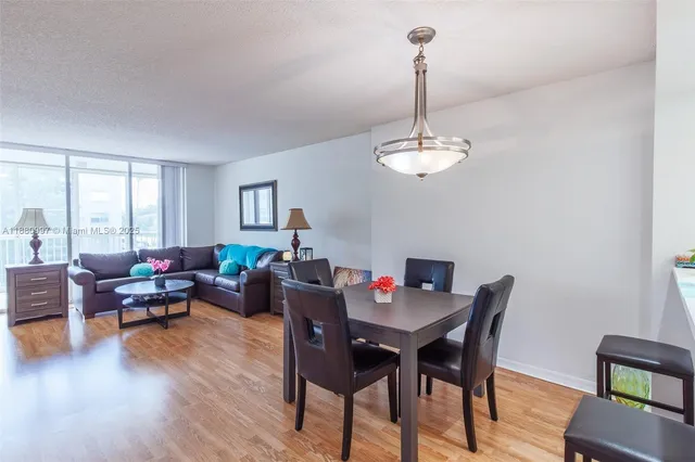 a view of a dining room with furniture window and wooden floor