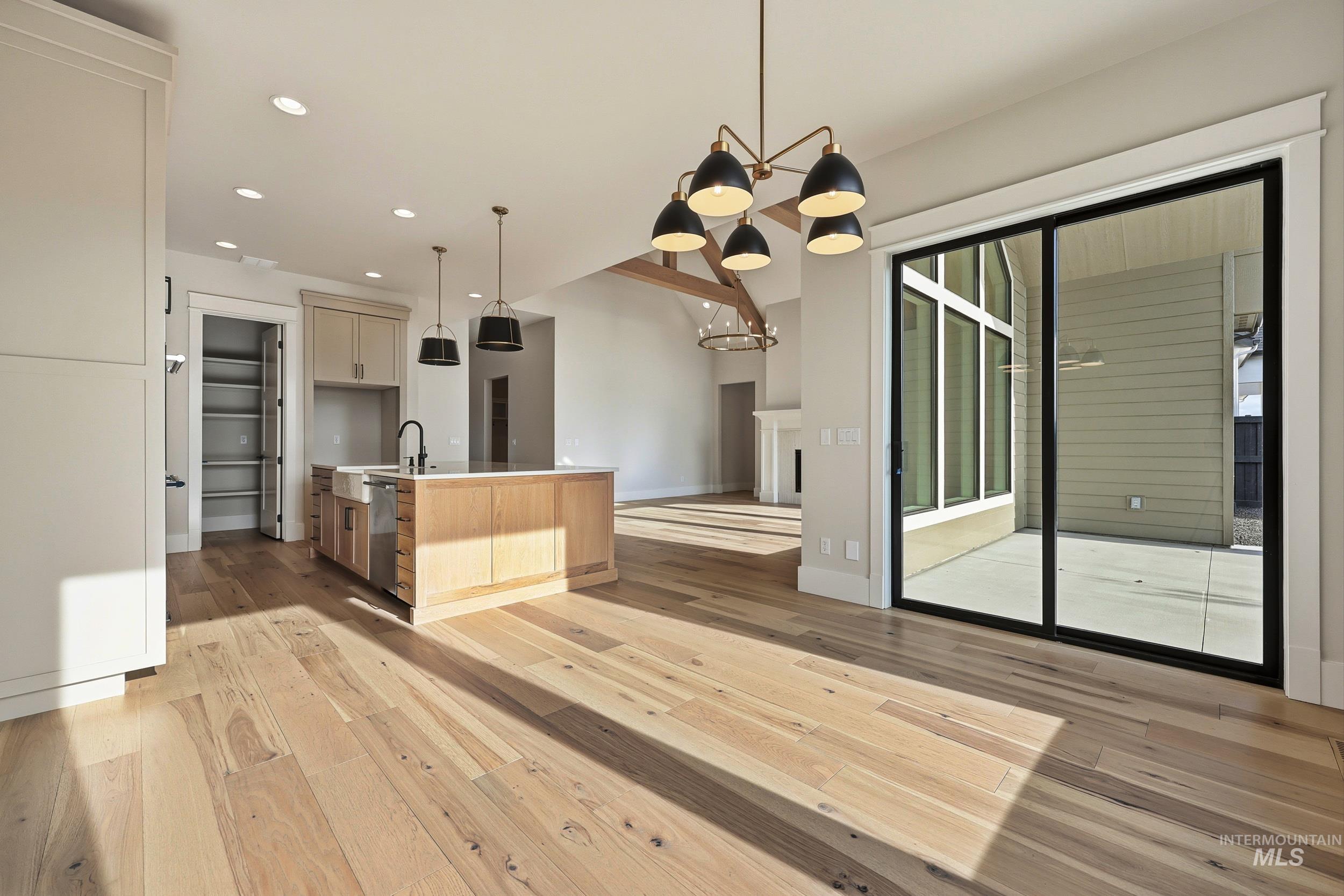 1090 East Crescendo Street Meridian, ID 83642 - Photo 43 of 43 Kitchen featuring a chandelier, pendant lighting, open floor plan, a center island with sink, and recessed lighting