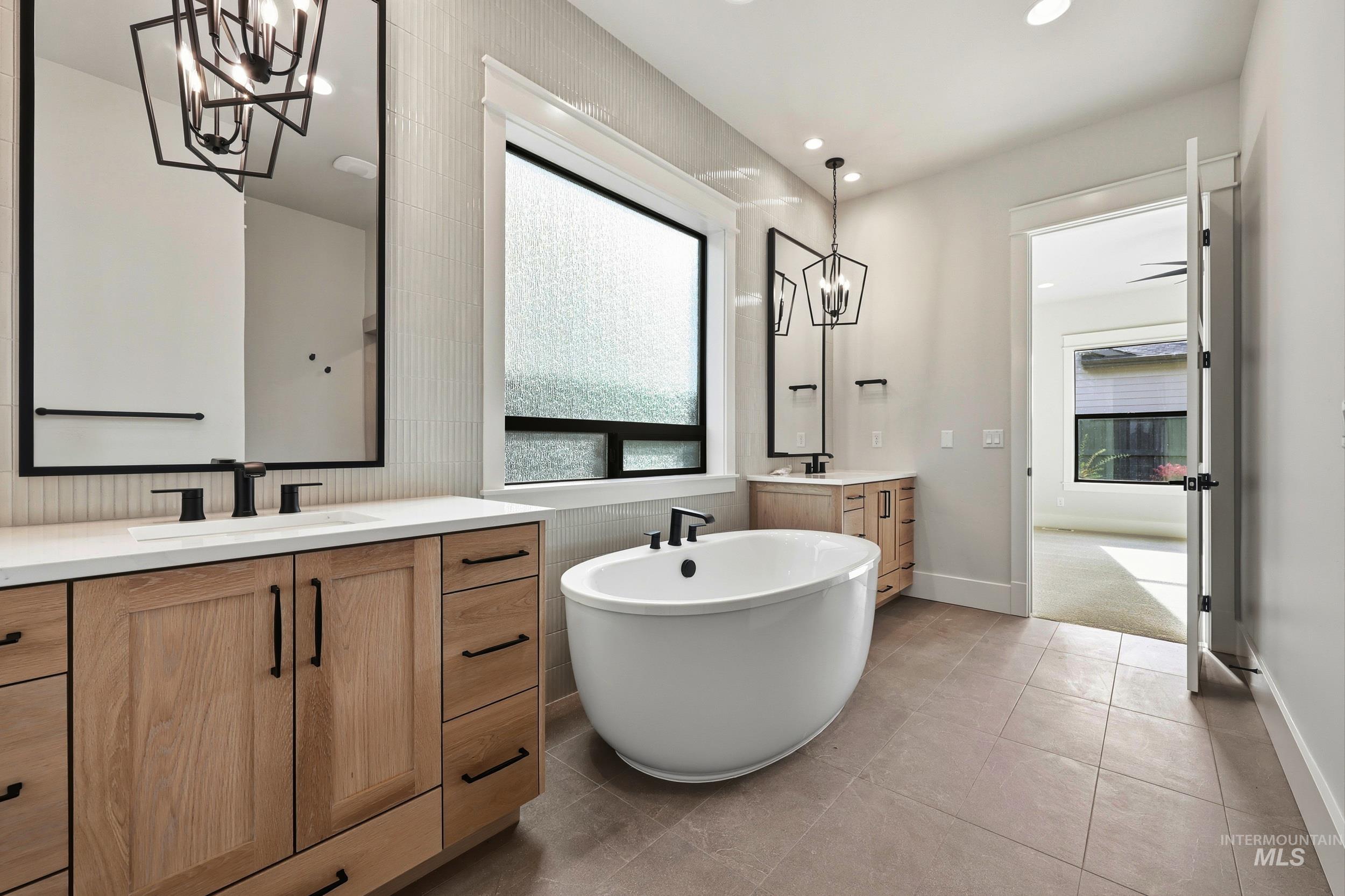1090 East Crescendo Street Meridian, ID 83642 - Photo 14 of 43 Bathroom with a chandelier, a freestanding tub, healthy amount of natural light, two vanities, and recessed lighting