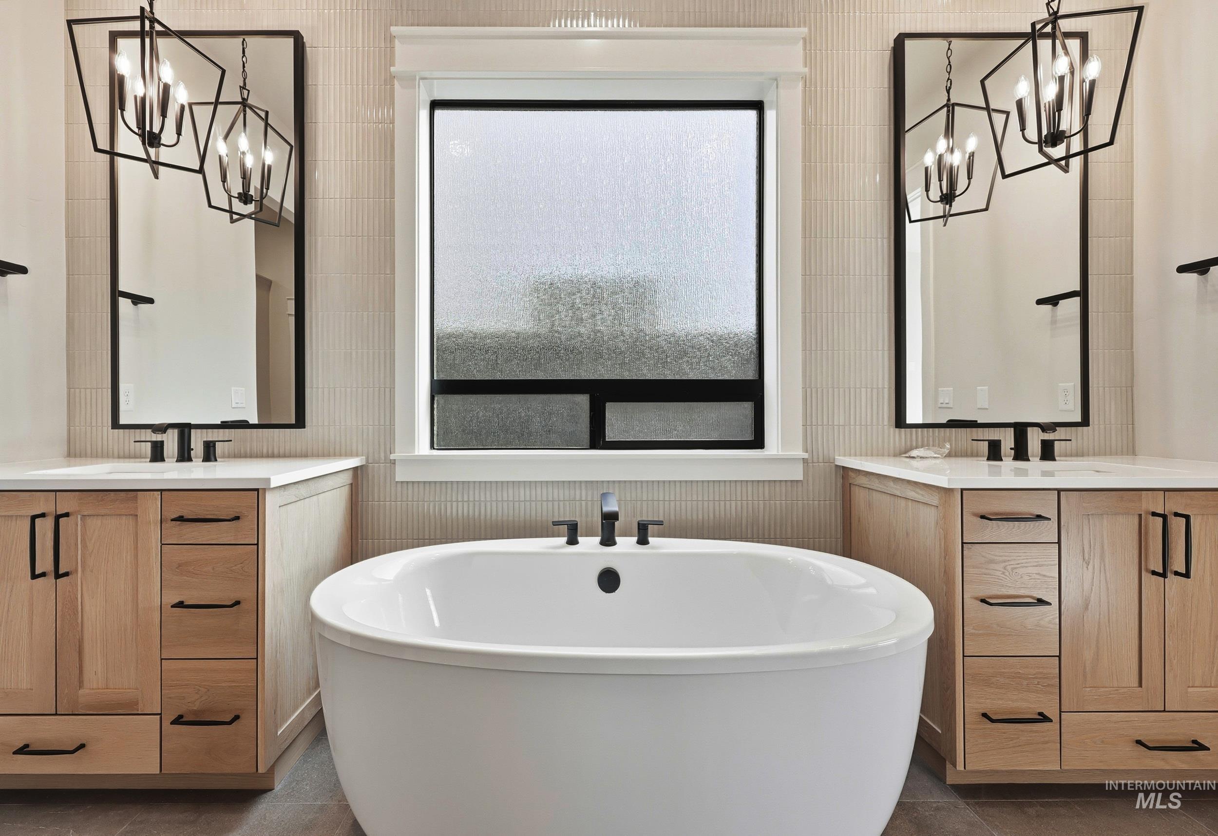 1090 East Crescendo Street Meridian, ID 83642 - Photo 15 of 43 Bathroom featuring a chandelier, two vanities, and a freestanding bath