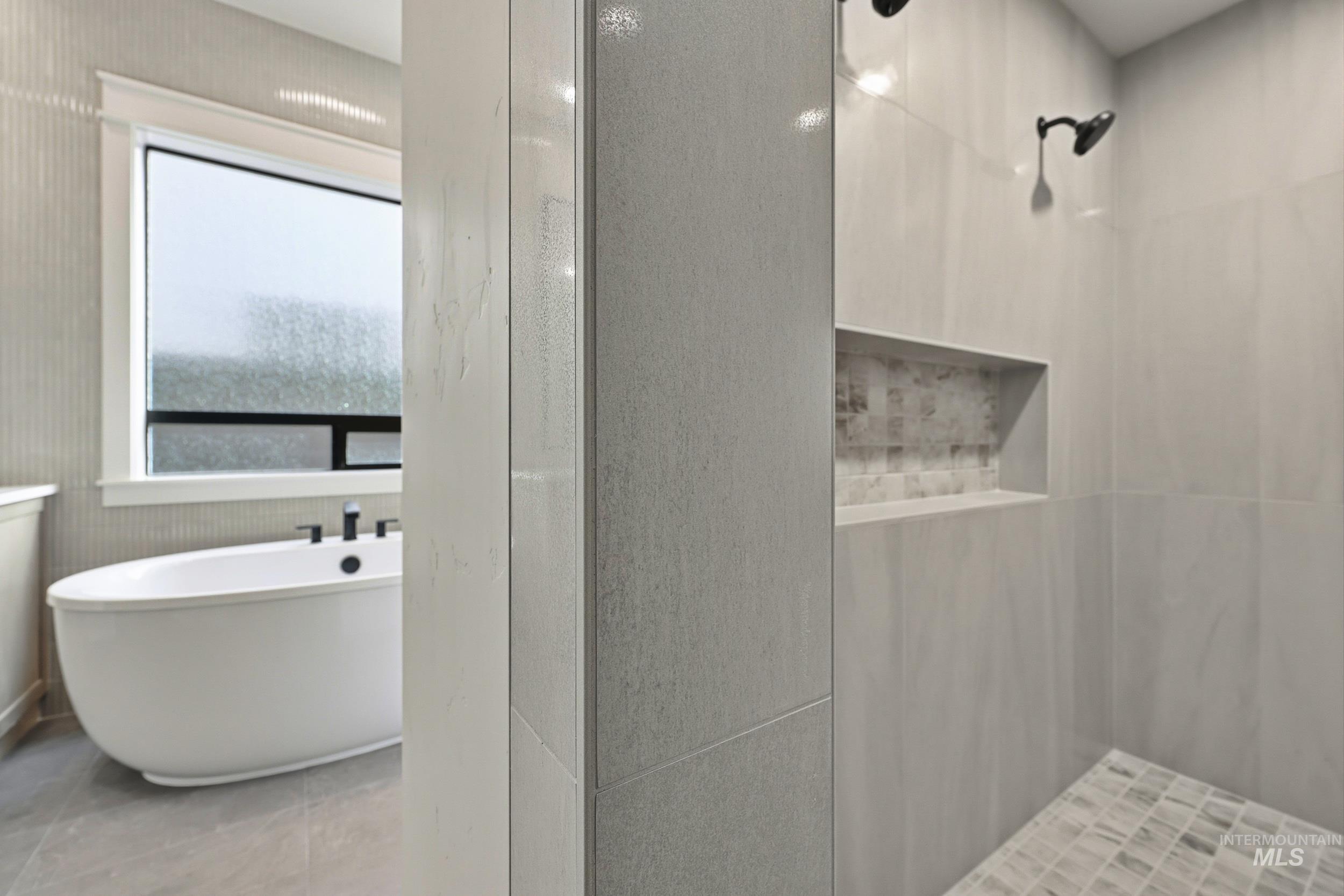 1090 East Crescendo Street Meridian, ID 83642 - Photo 17 of 43 Full bath featuring a freestanding tub, tiled shower, and light tile patterned floors