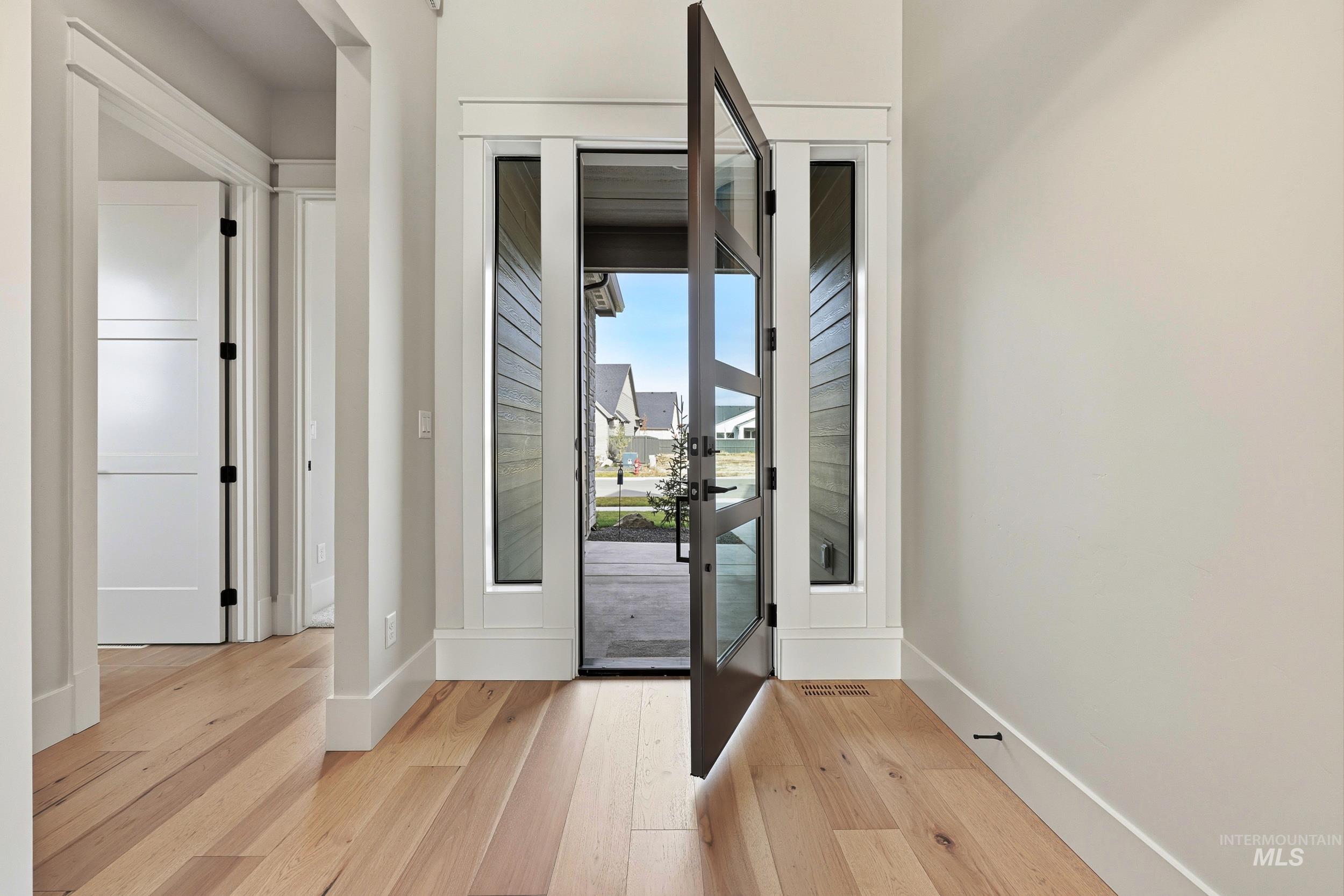 1090 East Crescendo Street Meridian, ID 83642 - Photo 19 of 43 Doorway featuring hardwood / wood-style floors and french doors