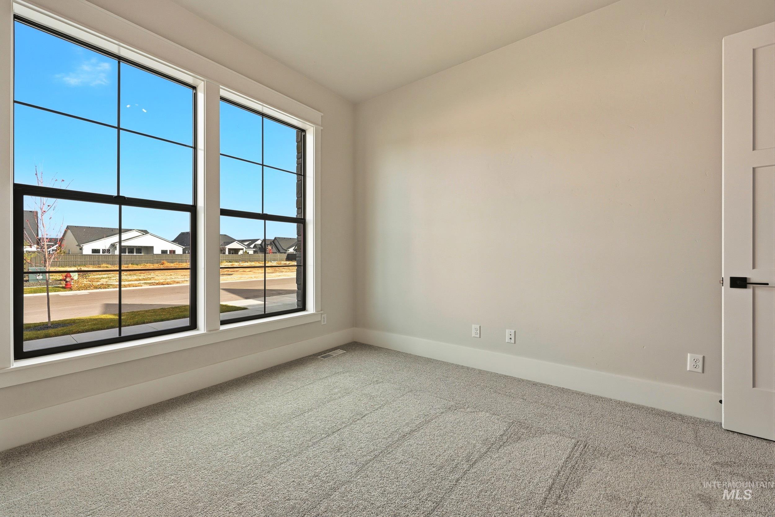 1090 East Crescendo Street Meridian, ID 83642 - Photo 22 of 43 Empty room featuring carpet and a residential view
