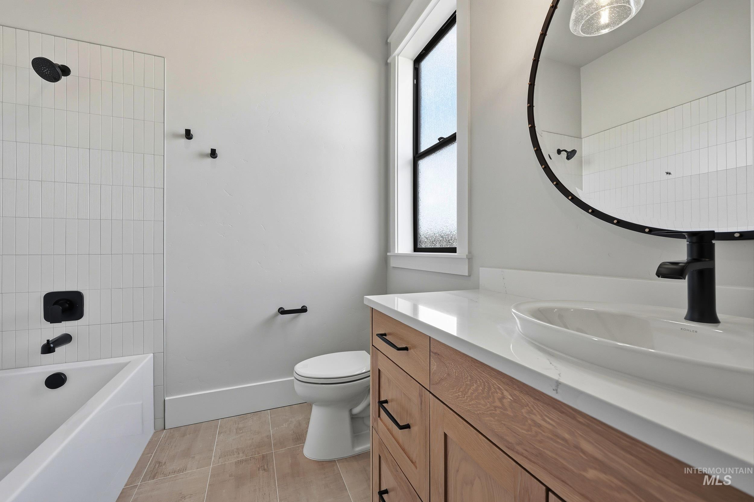 1090 East Crescendo Street Meridian, ID 83642 - Photo 24 of 43 Full bathroom with vanity, washtub / shower combination, and light tile patterned floors