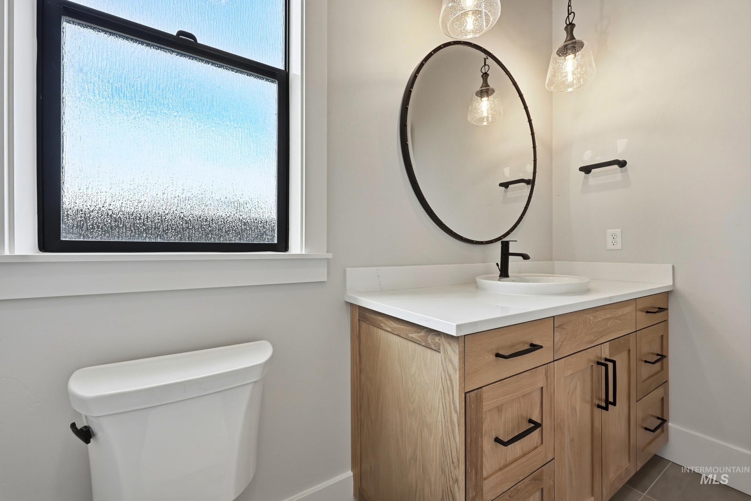 1090 East Crescendo Street Meridian, ID 83642 - Photo 25 of 43 Bathroom featuring vanity and light tile patterned floors
