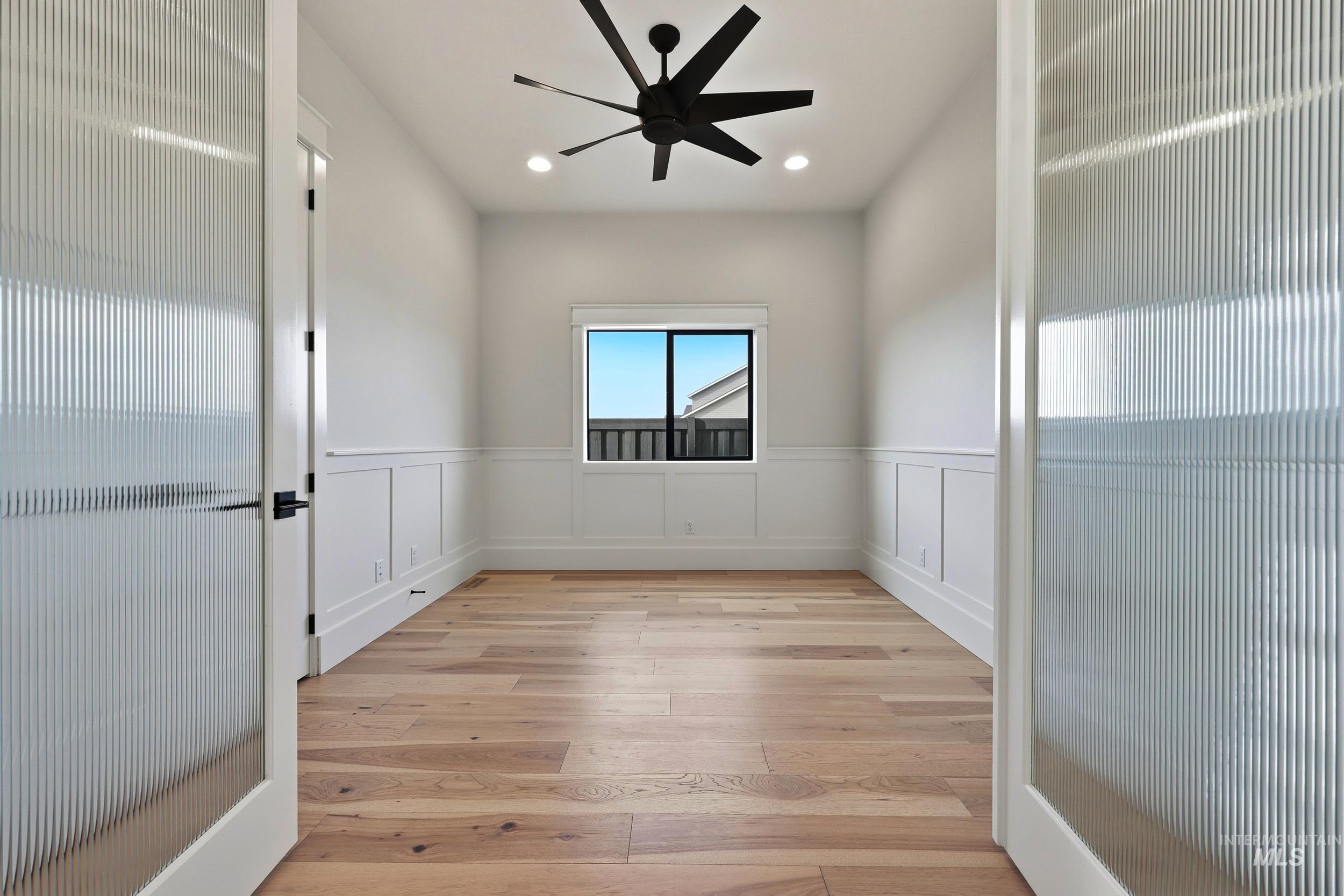 1090 East Crescendo Street Meridian, ID 83642 - Photo 27 of 43 Spare room featuring light wood finished floors, a decorative wall, recessed lighting, wainscoting, and ceiling fan