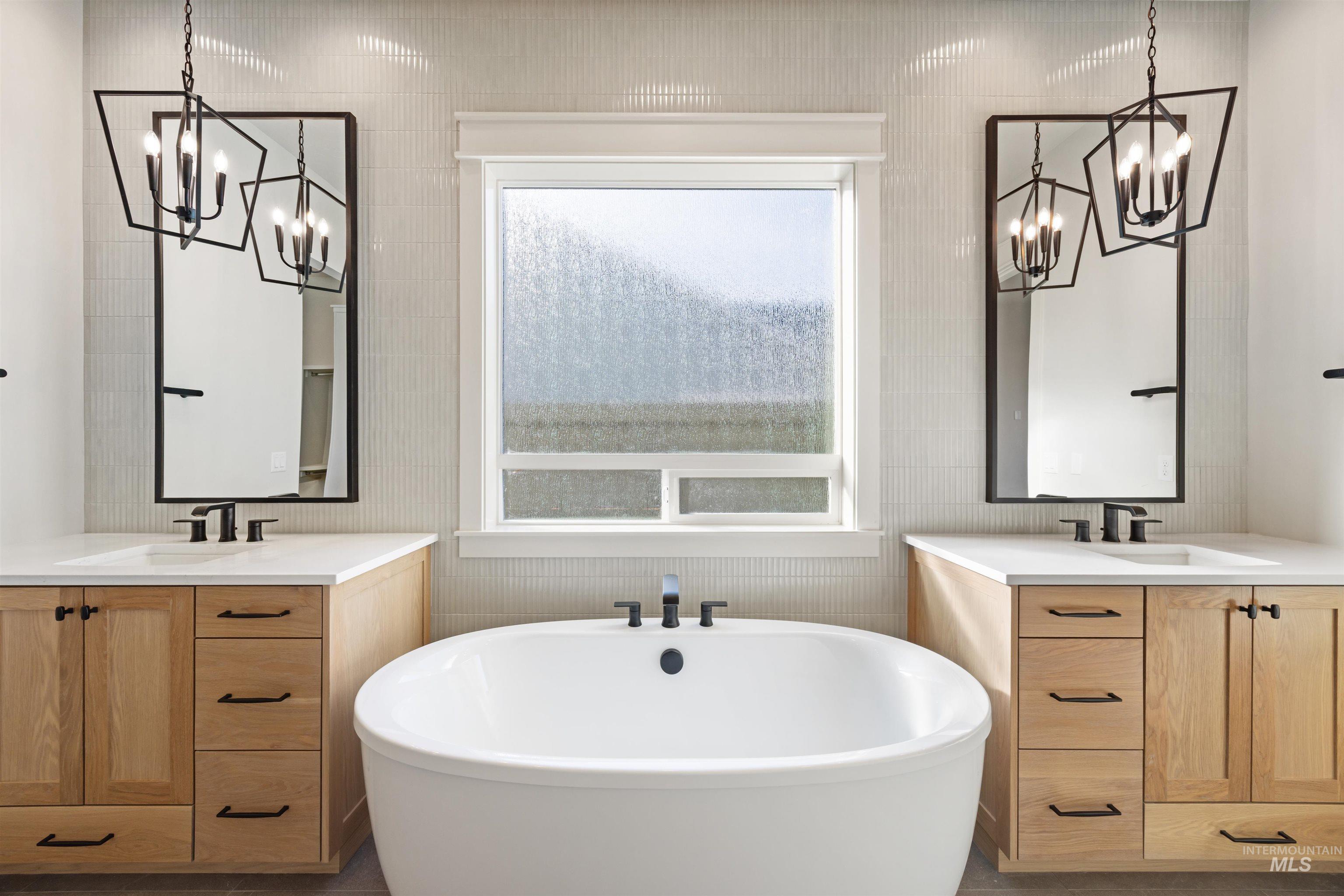 1090 East Crescendo Street Meridian, ID 83642 - Photo 29 of 50 Bathroom with hanging lights, two vanities, and a soaking tub