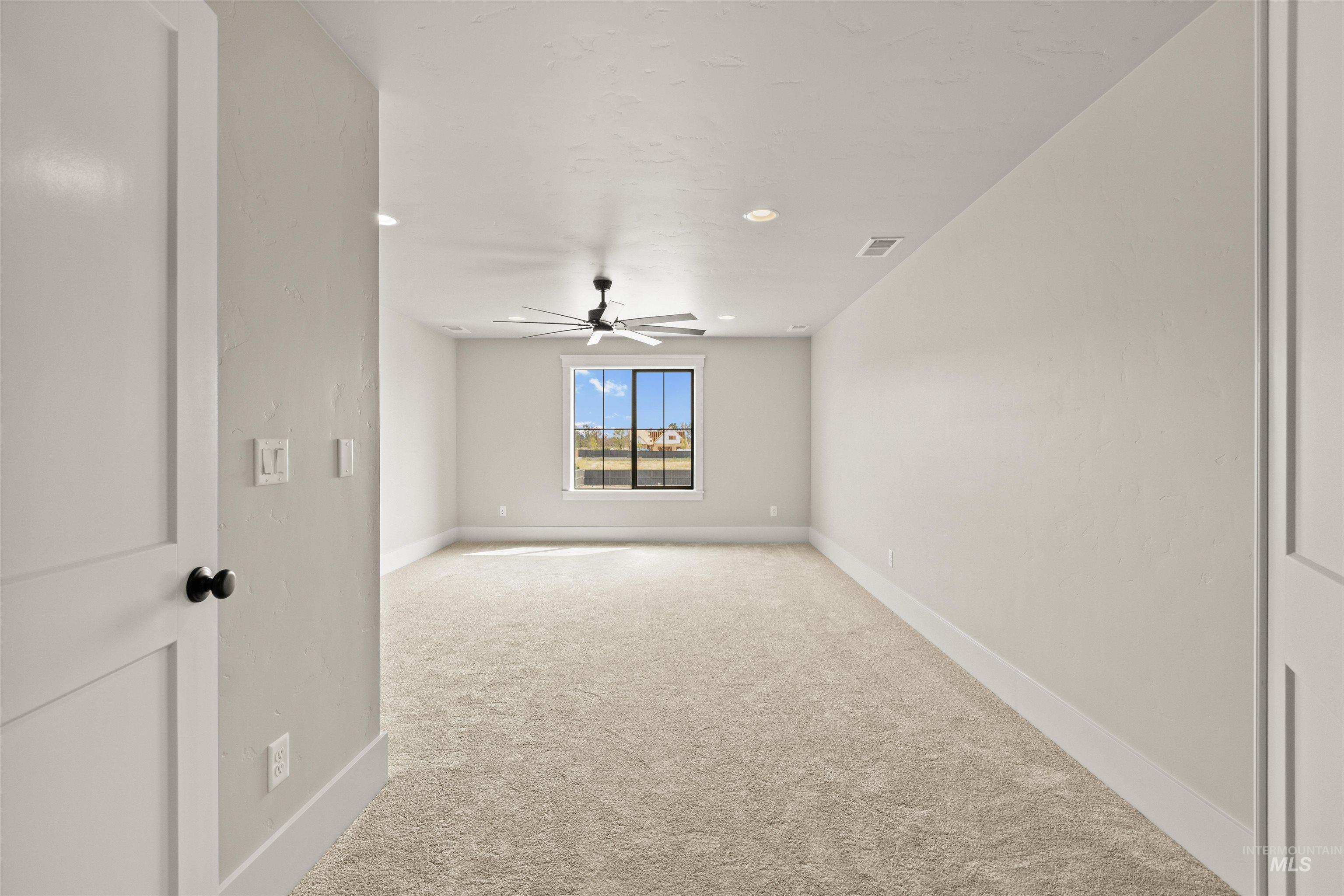 1090 East Crescendo Street Meridian, ID 83642 - Photo 38 of 43 Empty room featuring light carpet, recessed lighting, and ceiling fan
