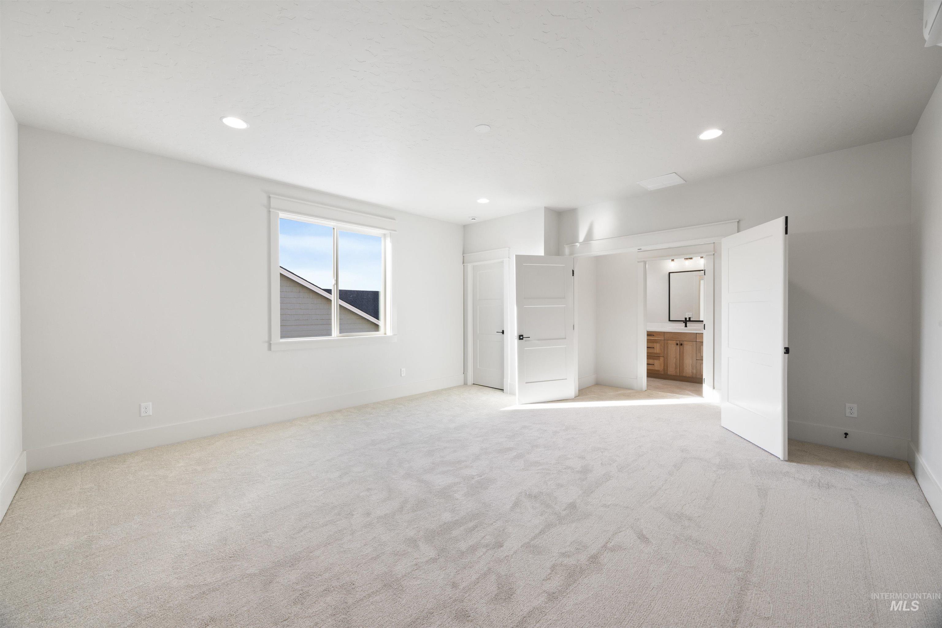 1090 East Crescendo Street Meridian, ID 83642 - Photo 38 of 50 Unfurnished bedroom featuring light carpet, connected bathroom, and recessed lighting