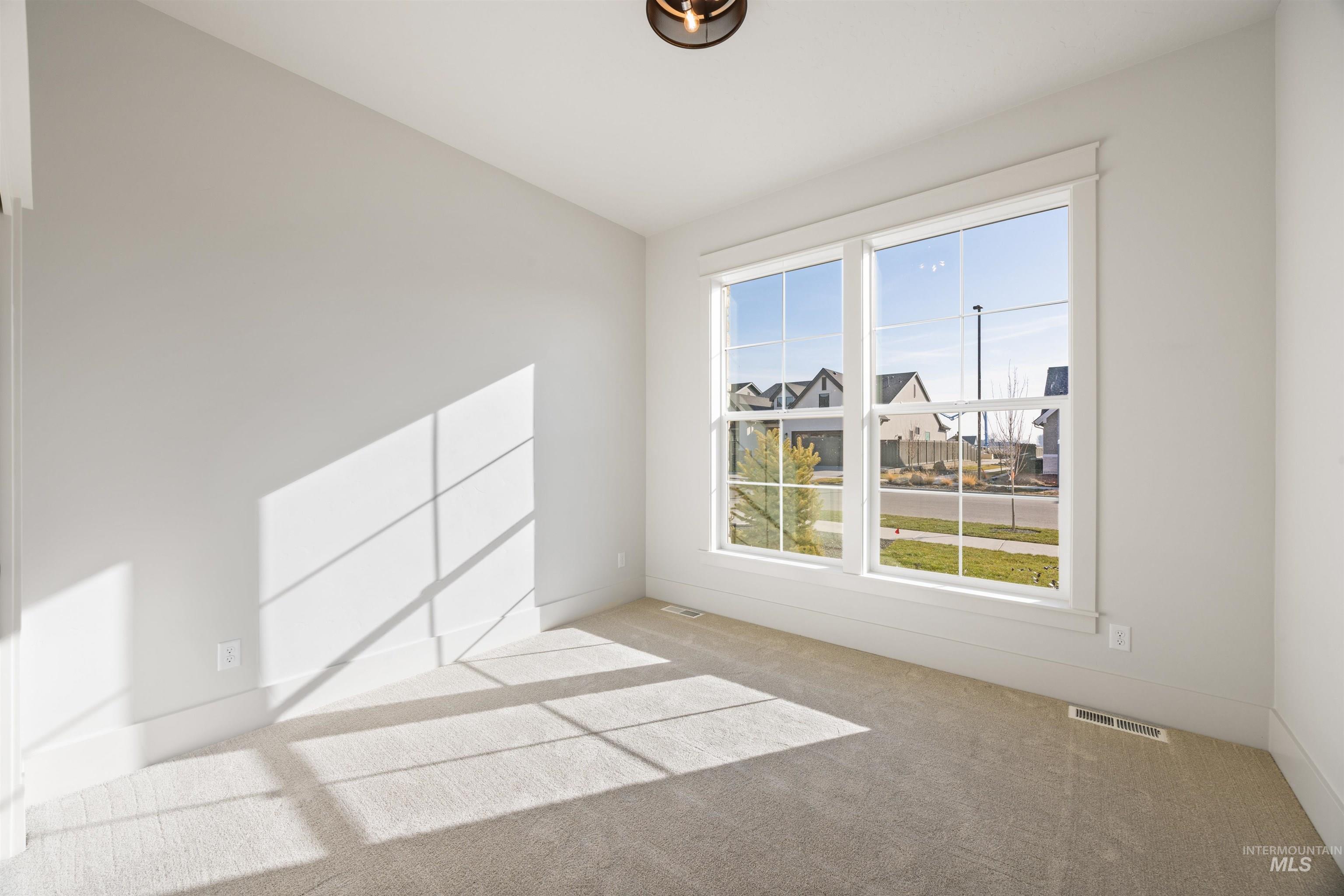 1090 East Crescendo Street Meridian, ID 83642 - Photo 4 of 50 Empty room with carpet flooring and baseboards