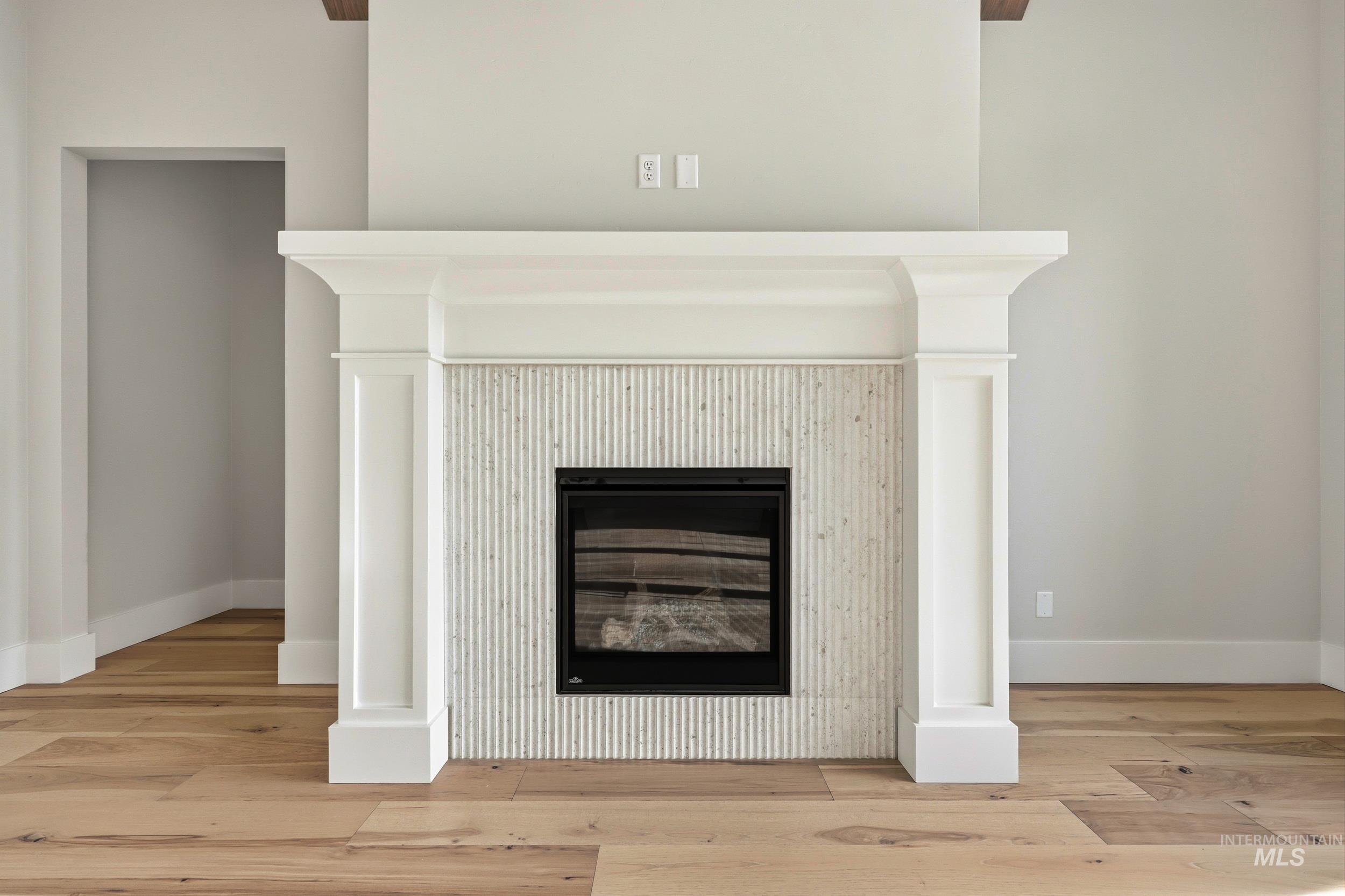 1090 East Crescendo Street Meridian, ID 83642 - Photo 4 of 43 Detailed view of wood finished floors and a glass covered fireplace