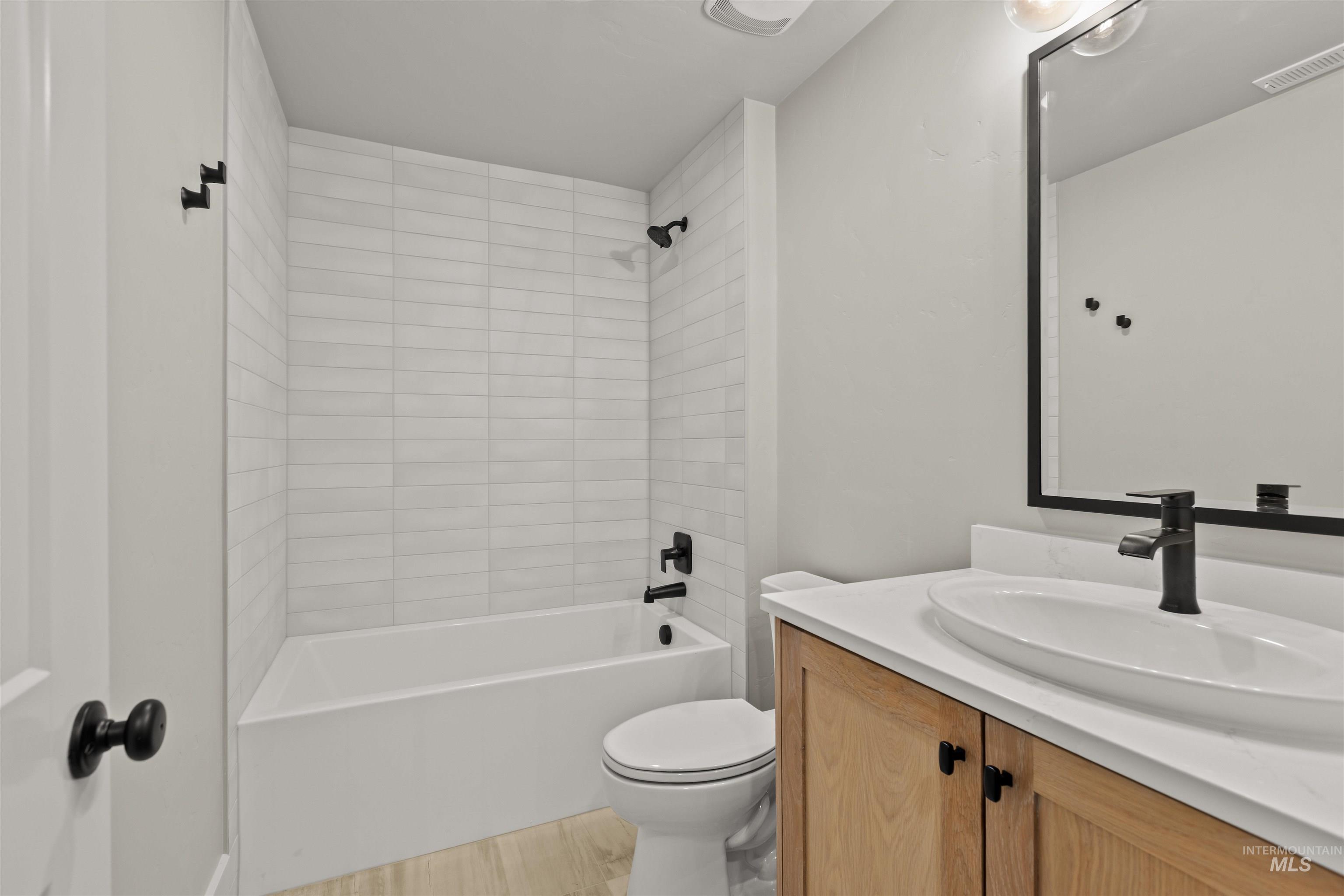 1090 East Crescendo Street Meridian, ID 83642 - Photo 40 of 43 Full bathroom featuring vanity, shower / tub combination, and light wood finished floors