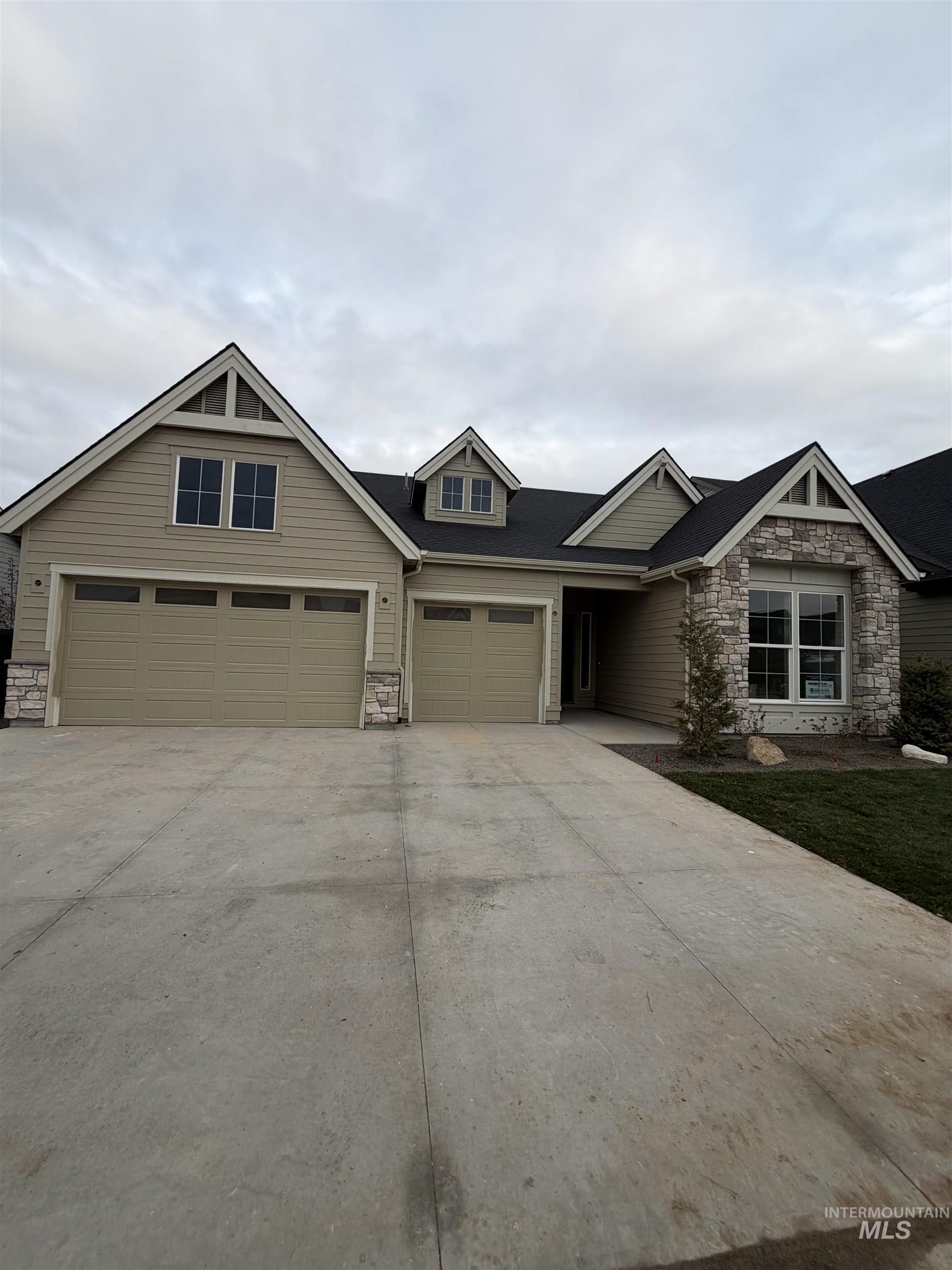 1090 East Crescendo Street Meridian, ID 83642 - Photo 41 of 43 View of front of property featuring stone siding and concrete driveway