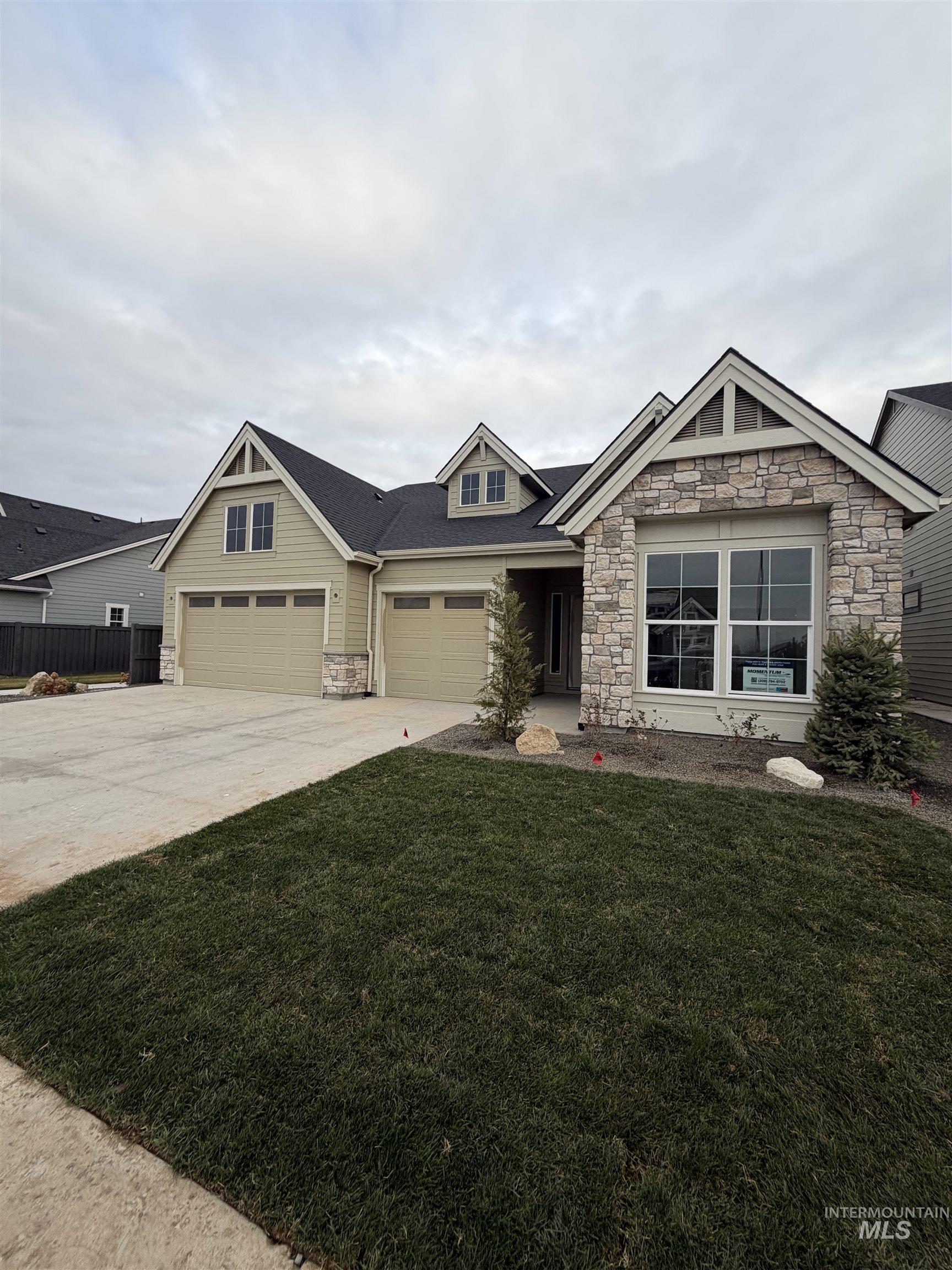 1090 East Crescendo Street Meridian, ID 83642 - Photo 42 of 43 Craftsman-style house with stone siding and driveway