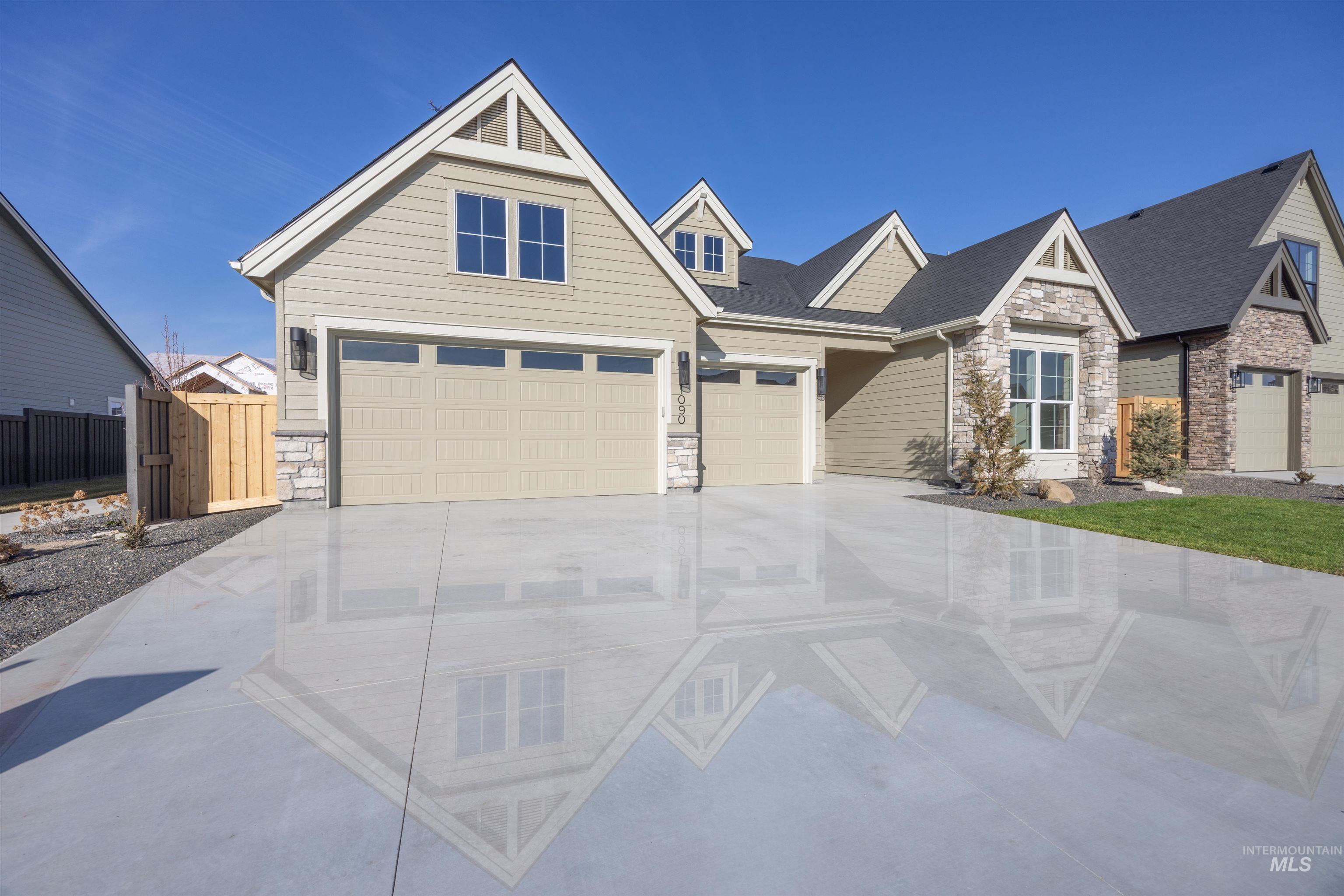 1090 East Crescendo Street Meridian, ID 83642 - Photo 46 of 50 Craftsman inspired home featuring stone siding, concrete driveway, an attached garage, and a shingled roof