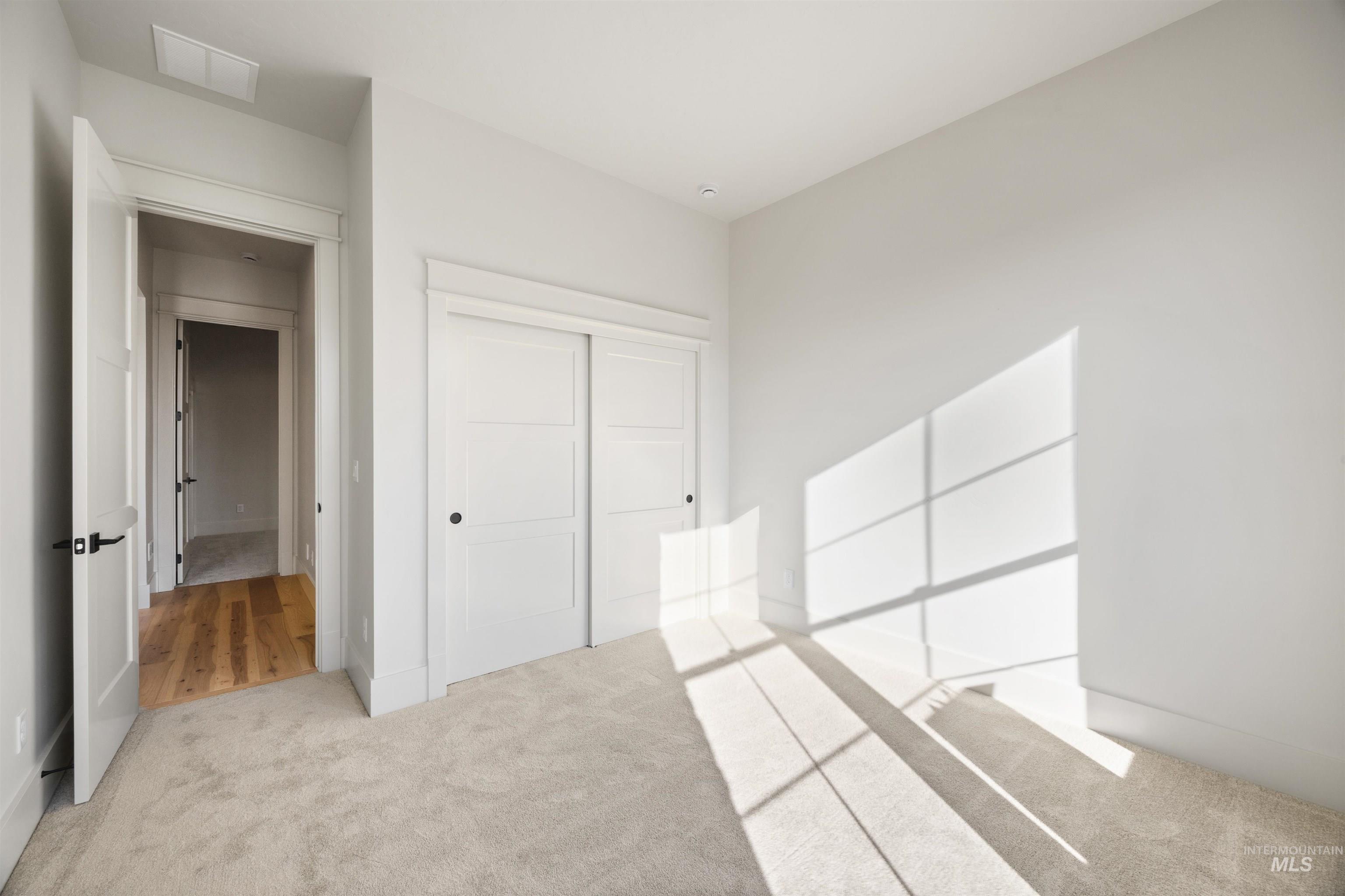 1090 East Crescendo Street Meridian, ID 83642 - Photo 5 of 50 Unfurnished bedroom featuring carpet and a closet