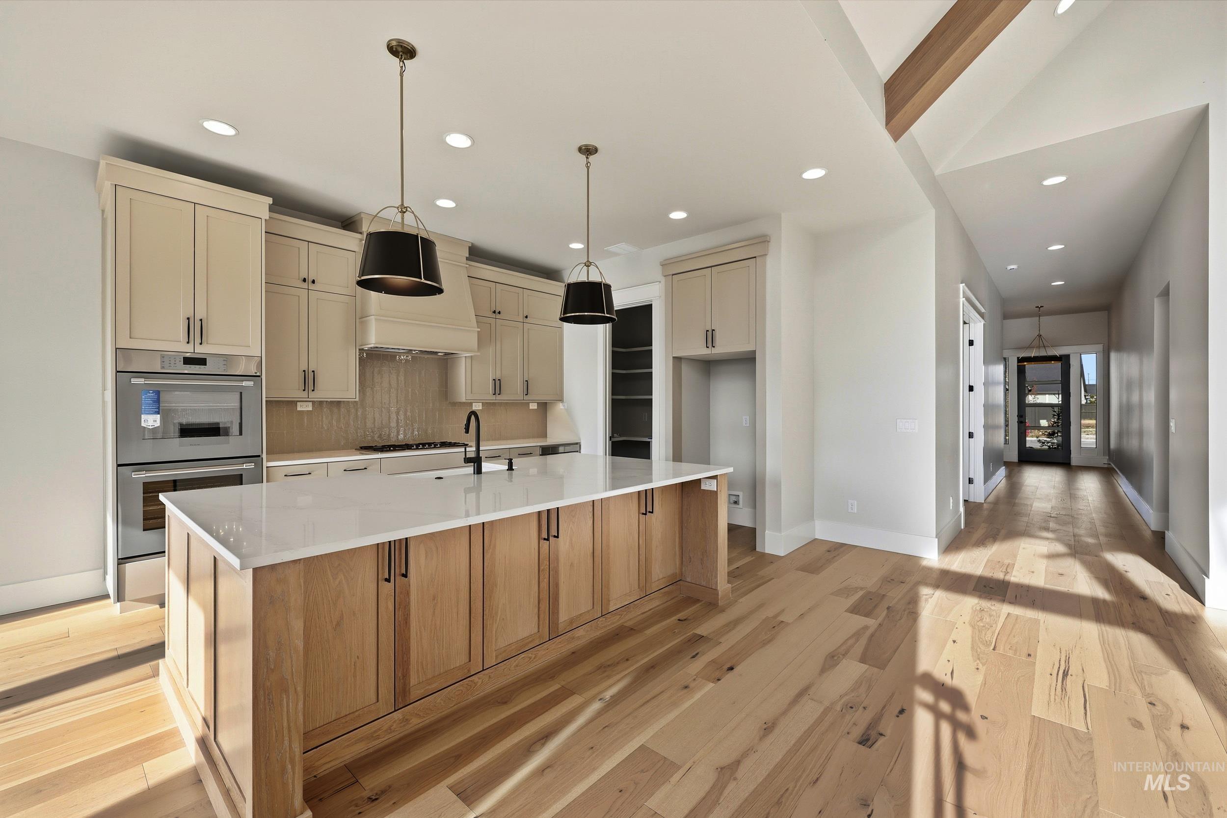 1090 East Crescendo Street Meridian, ID 83642 - Photo 6 of 43 Kitchen with backsplash, stainless steel double oven, pendant lighting, recessed lighting, and light stone counters