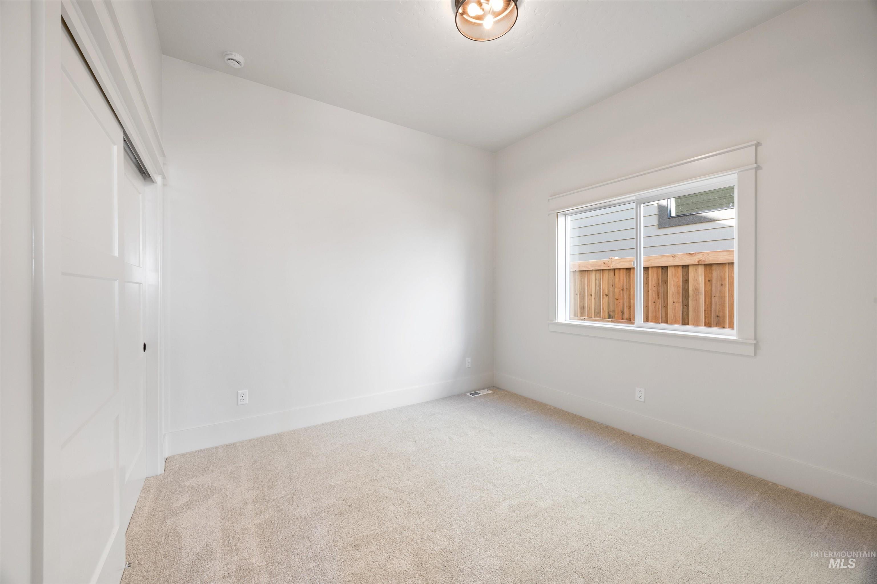 1090 East Crescendo Street Meridian, ID 83642 - Photo 7 of 50 Unfurnished bedroom featuring a closet and light colored carpet