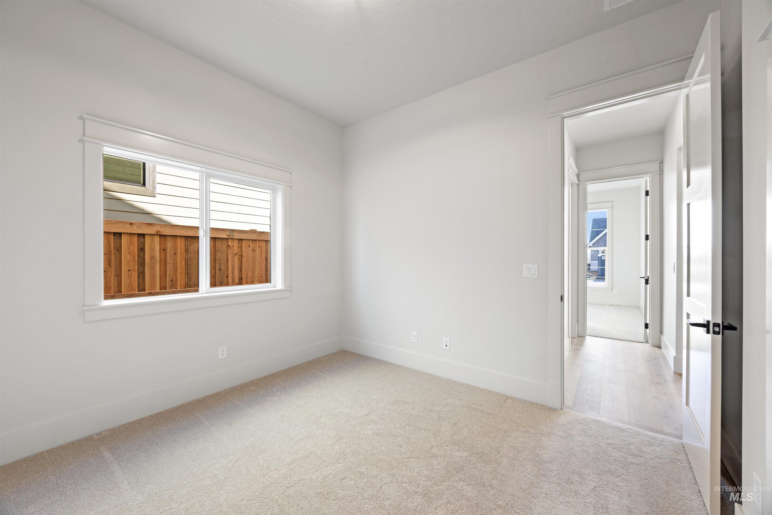 1090 East Crescendo Street Meridian, ID 83642 - Photo 8 of 50 Spare room featuring light carpet and baseboards