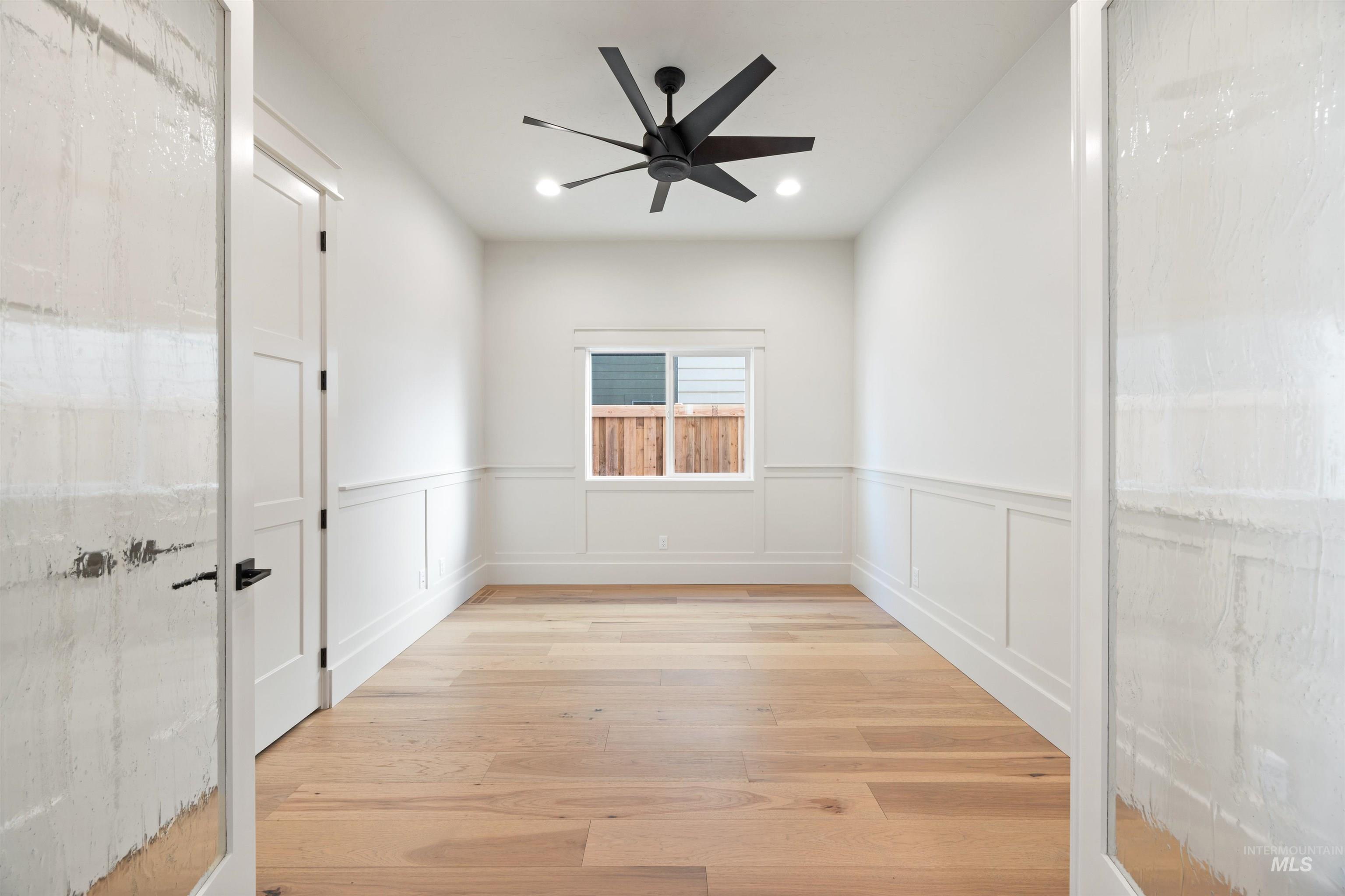 1090 East Crescendo Street Meridian, ID 83642 - Photo 9 of 50 Spare room with wainscoting, light wood-style floors, a decorative wall, ceiling fan, and recessed lighting