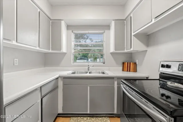 a kitchen with a sink stove and microwave