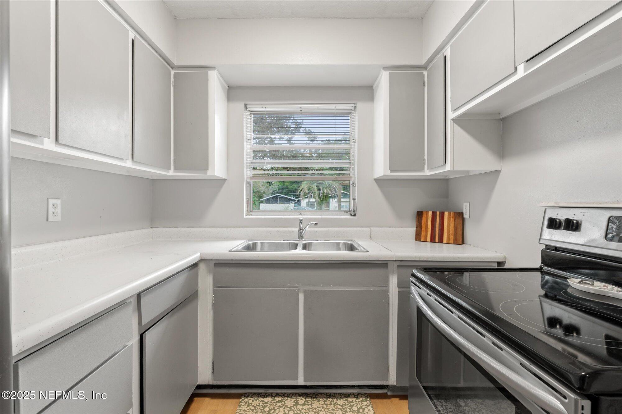 2025 Kate Street Palatka, FL 32177 - Photo 13 of 36 a kitchen with a sink stove and microwave