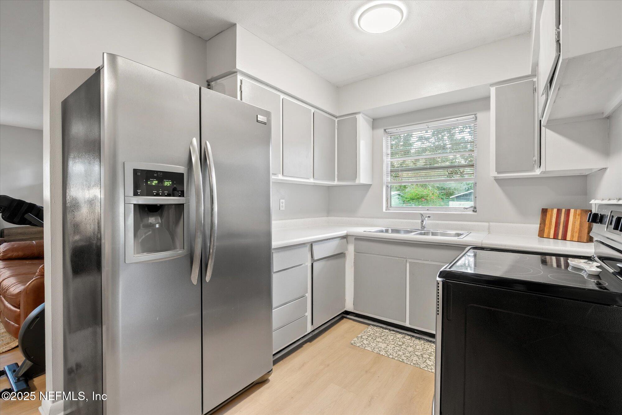 2025 Kate Street Palatka, FL 32177 - Photo 14 of 36 a kitchen with stainless steel appliances granite countertop a refrigerator and a sink