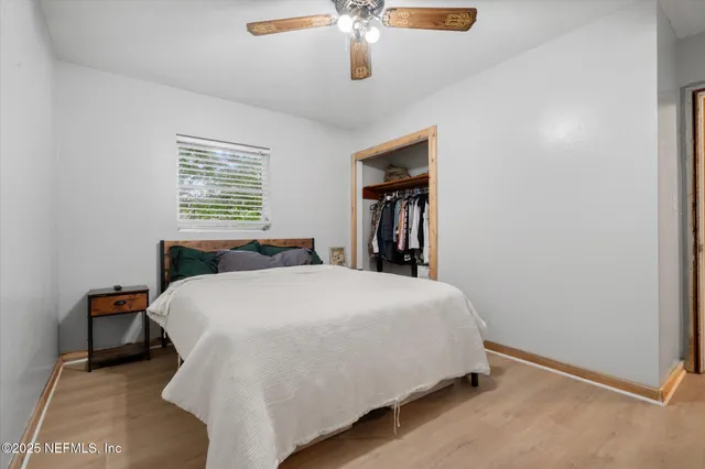 a large bed sitting in a bedroom next to a window
