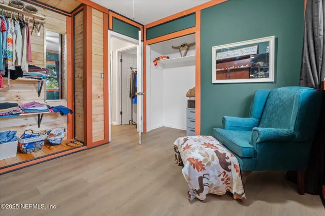 a bedroom with furniture and a window