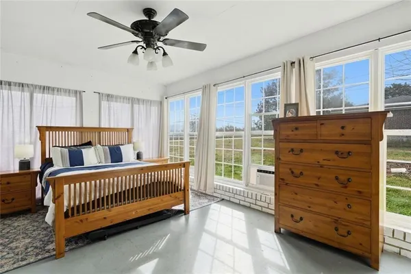 a living room with stainless steel appliances wooden floor and chandelier