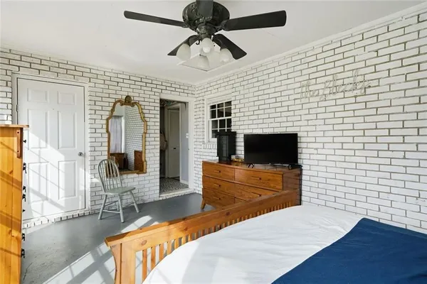 a bedroom with a window and wooden floor