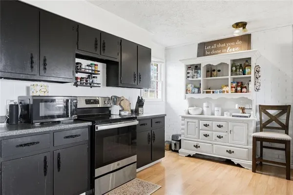 a kitchen with stainless steel appliances a refrigerator and cabinets