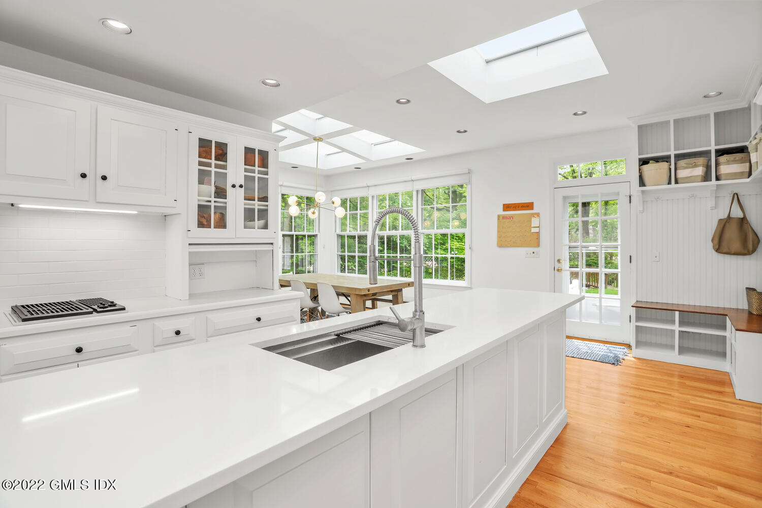 72 Lockwood Road Riverside, CT 06878 - Photo 13 of 23 a kitchen that has a sink and a stove with wooden floor