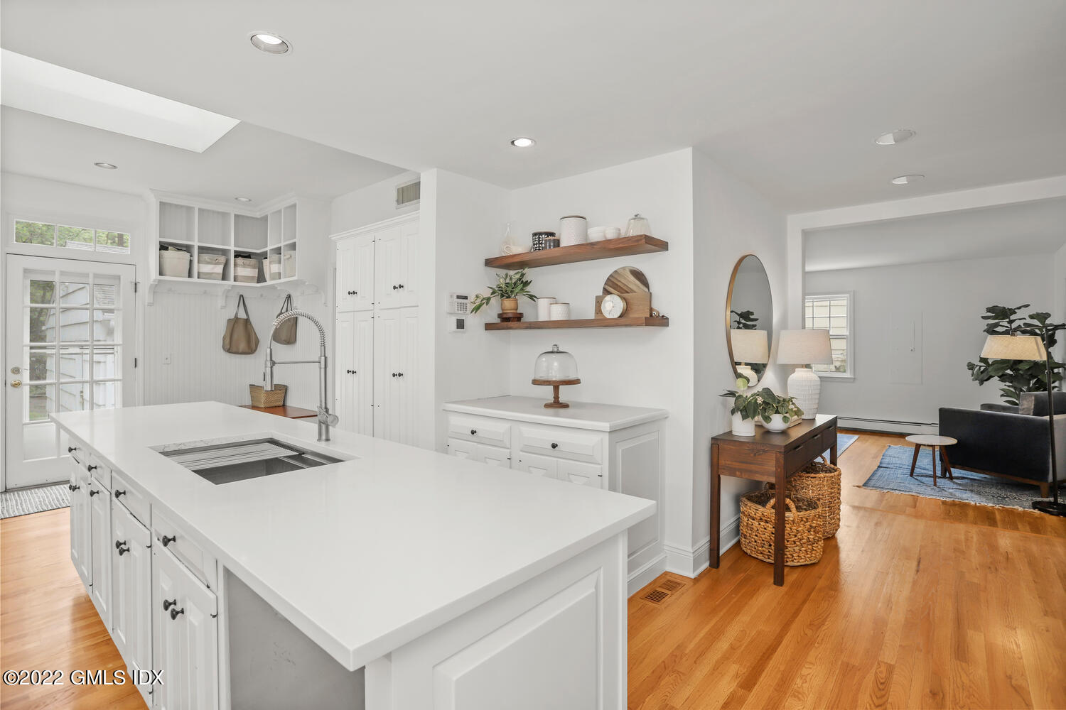 72 Lockwood Road Riverside, CT 06878 - Photo 15 of 23 a kitchen with stainless steel appliances a white stove top oven and white cabinets next to a window